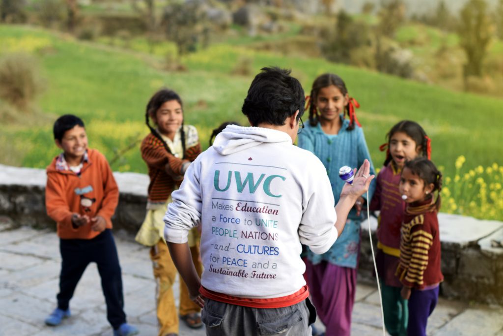 UWC Mahindra student playing with local children CAS